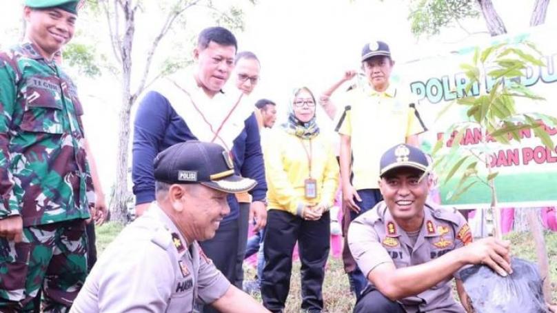 Bupati dan Kapolres Mukomuko tengah menanam pohon.